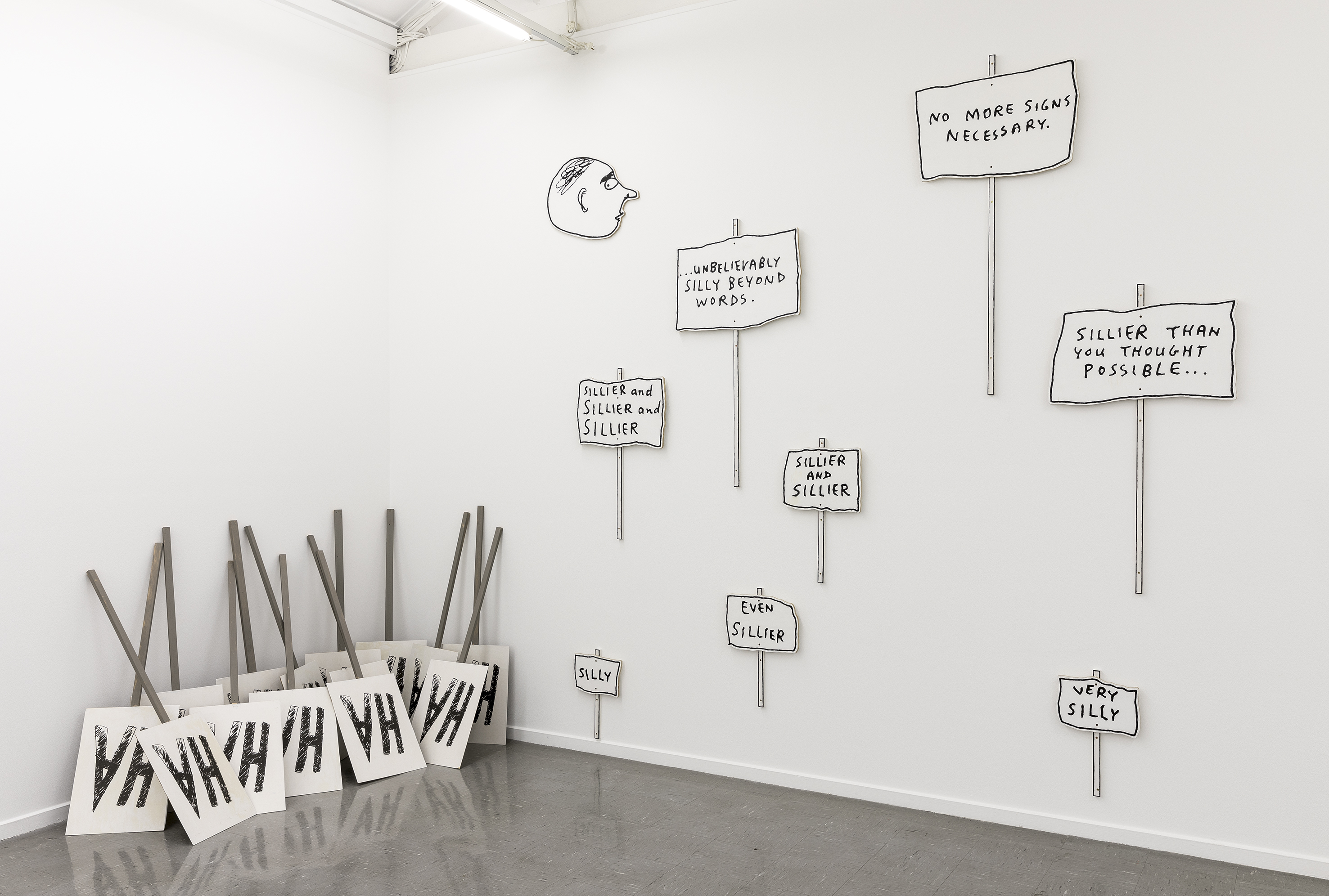 L to R:   Aleks Danko, ‘…you might as well laugh mate, there’s nothing else to do…’  (2017), silk-screened texts on plywood, wood and acrylic paint, dimensions variable; Aleks Danko, 'David Shrigley meet Michael Leunig' (2009–2017), acrylic on plywood 360 x 450 cm
